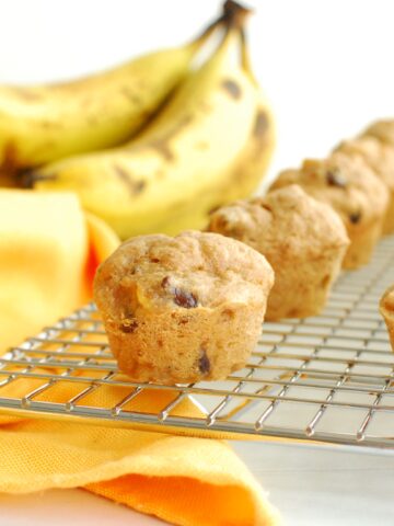 A peanut butter banana mini muffin on a cooling rack.