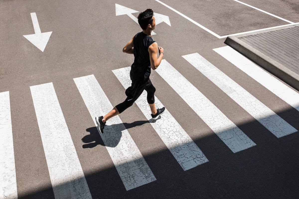 A male runner on a city street.