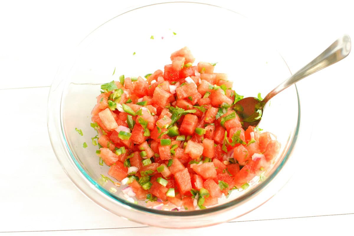 Watermelon salsa in a glass mixing bowl.