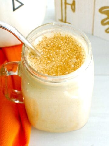 An overhead shot of a protein iced pumpkin spice latte garnished with a sprinkle of pumpkin spice.