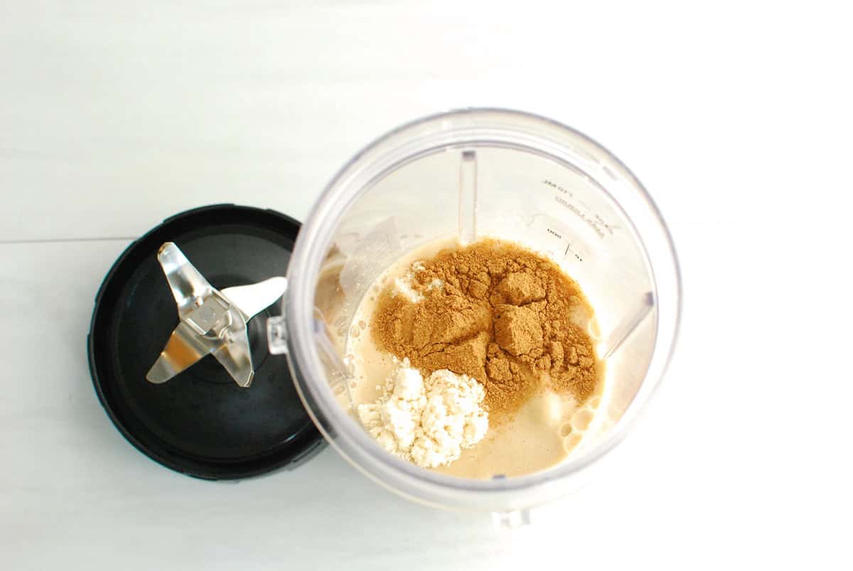 All of the drink ingredients in a blender cup.