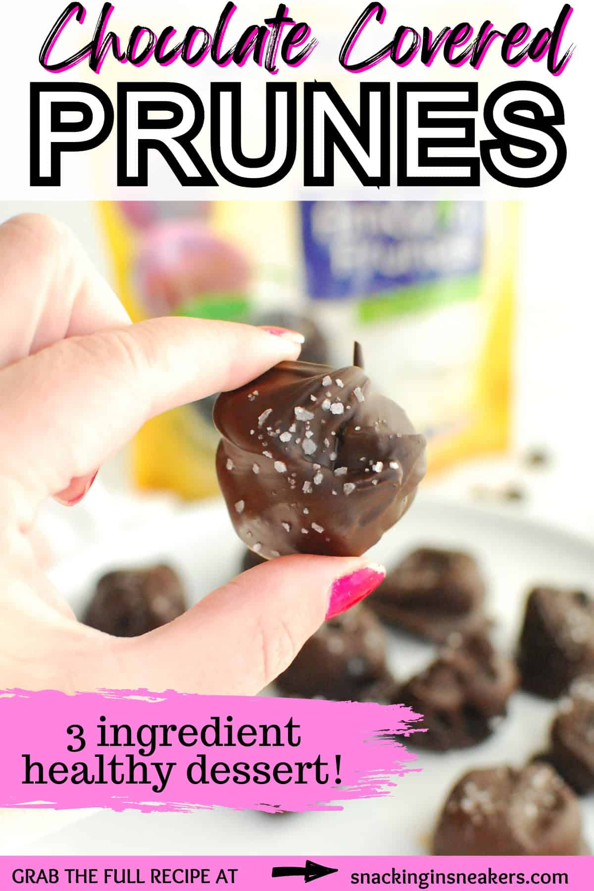 A woman's hand holding a chocolate covered prune, with a text overlay with the name of the recipe.
