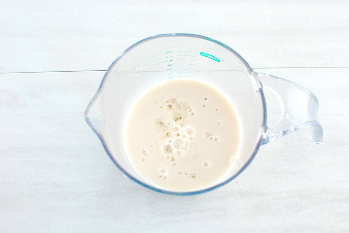 Milk and vinegar mixed together in a measuring cup.