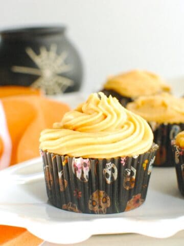 A healthy Halloween cupcake on a platter next to an orange napkin.