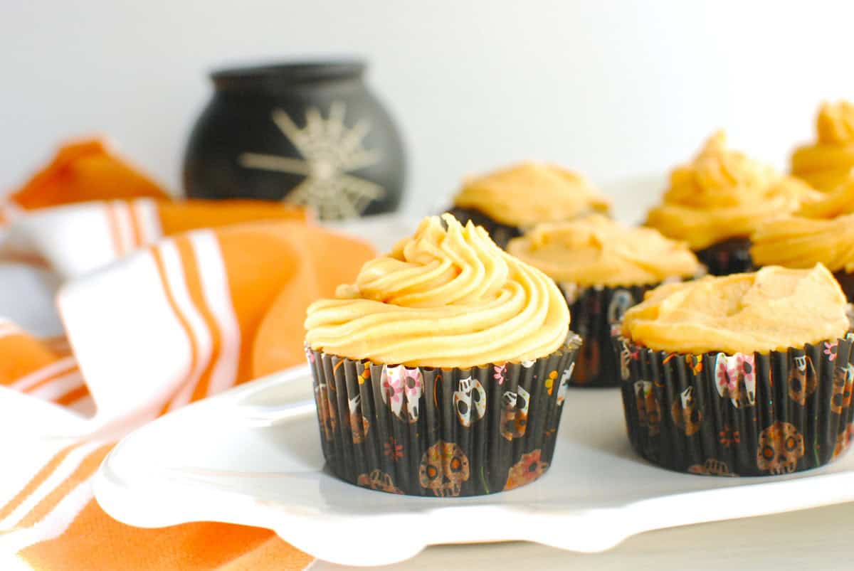 A healthy Halloween cupcake on a platter next to an orange napkin.