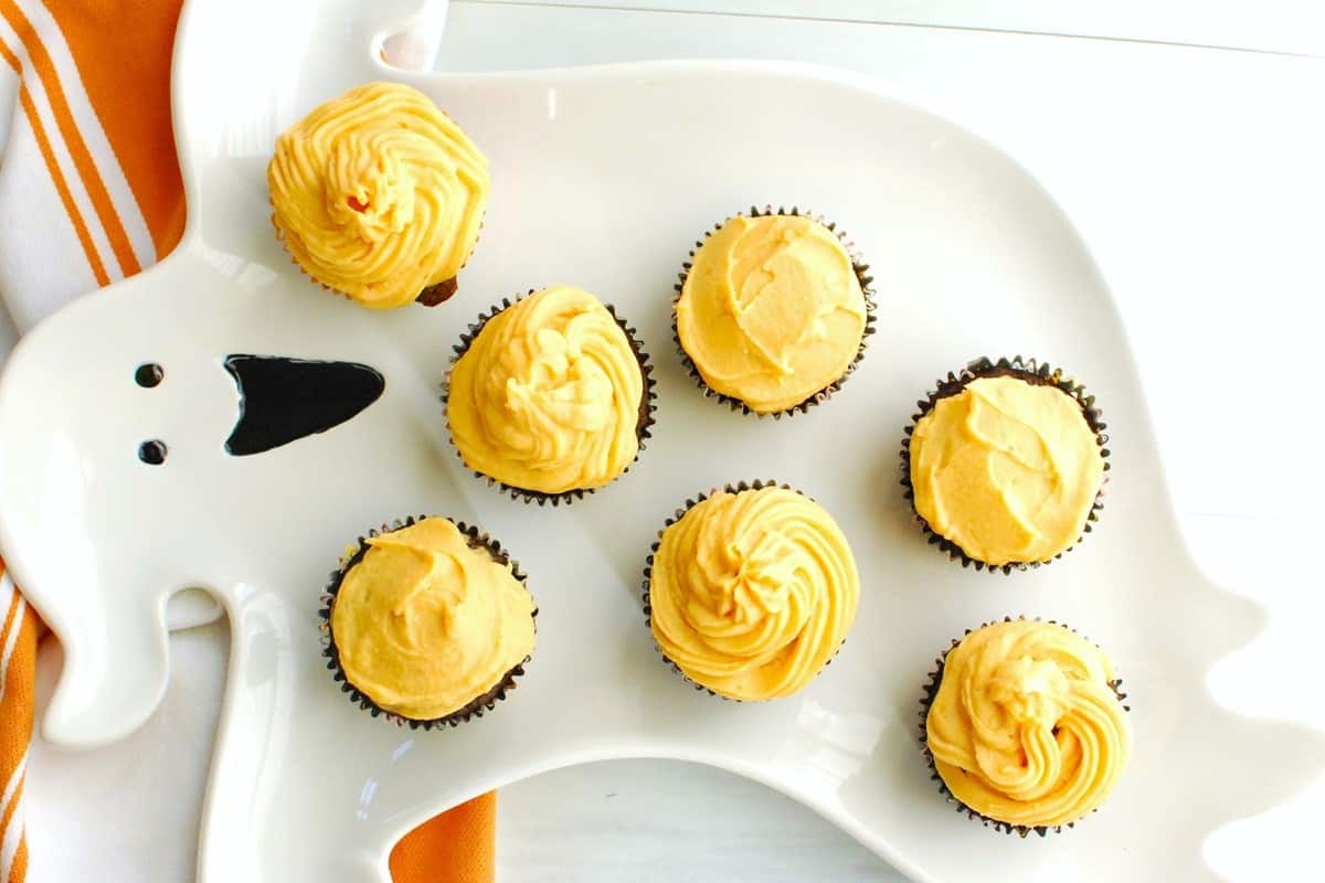 A bunch of sweetpotato cupcakes on a Halloween tray.