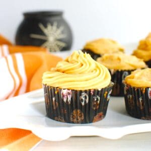 A chocolate sweetpotato cupcake with a vanilla white chocolate sweetpotato frosting, in a Halloween cupcake liner.