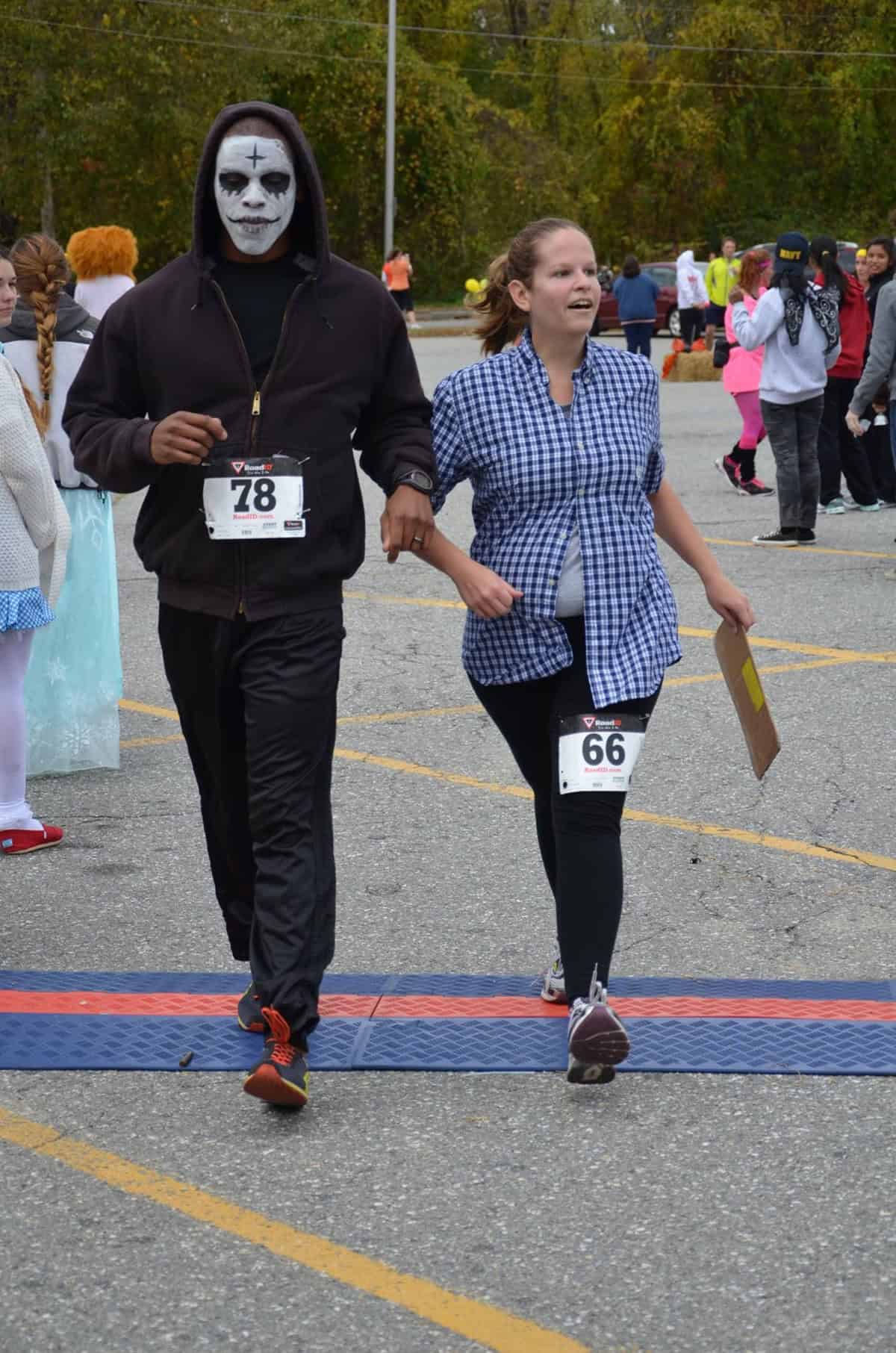Running across a finish line in costume.
