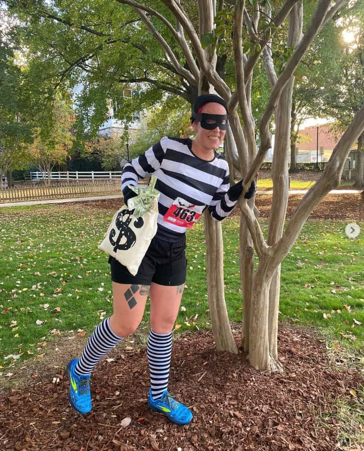 A woman dressed as a bank robber for a Halloween race.