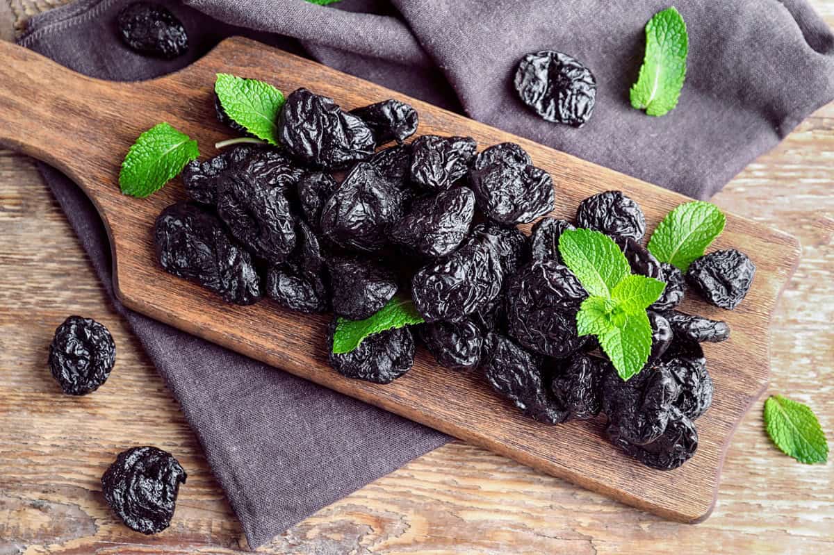 Prunes on a wooden board.