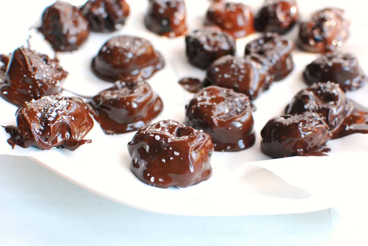 Chocolate covered prunes that have just been sprinkled with salt.
