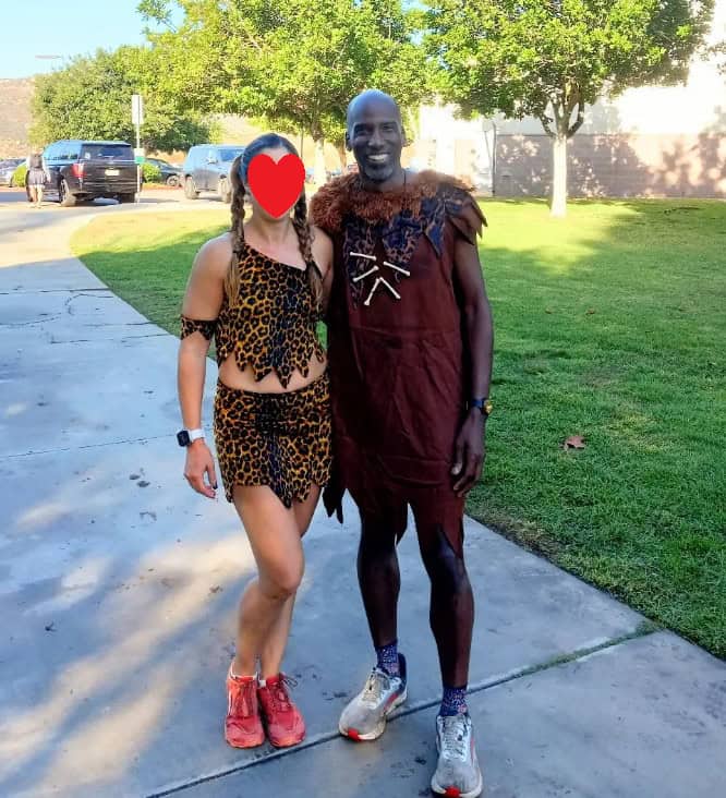 A man and woman dressed as stone age characters for a road race.