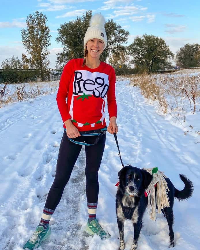 A woman and a dog in a pasta sauce and pasta costume for running.