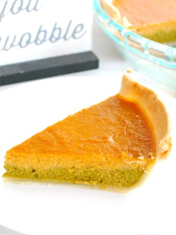 A slice of matcha pumpkin pie on a white plate.