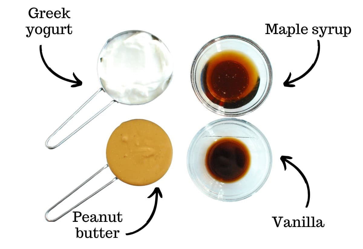 Yogurt, peanut butter, maple syrup, and vanilla, all on a white backdrop.