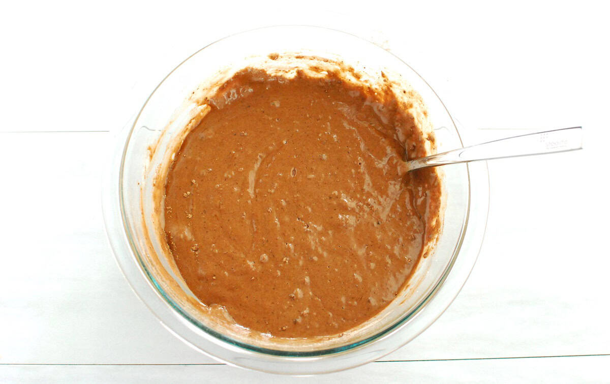 Chocolate cake batter in a glass mixing bowl.