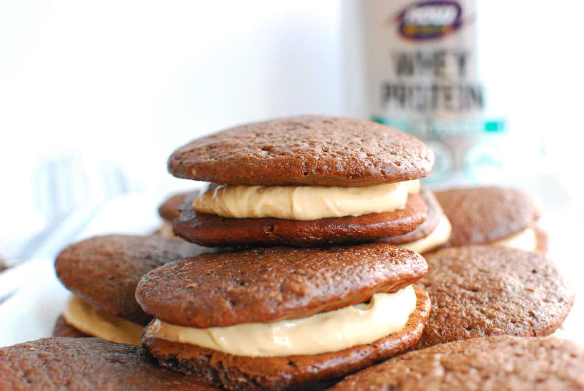 A chocolate peanut butter protein whoopie pie stacked on more whoopie pies.