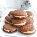 A bunch of protein whoopie pies on a white platter.