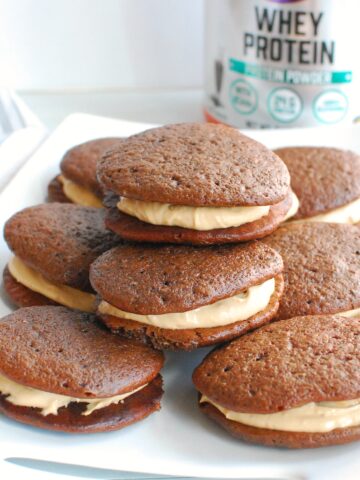 A bunch of protein whoopie pies on a white platter.