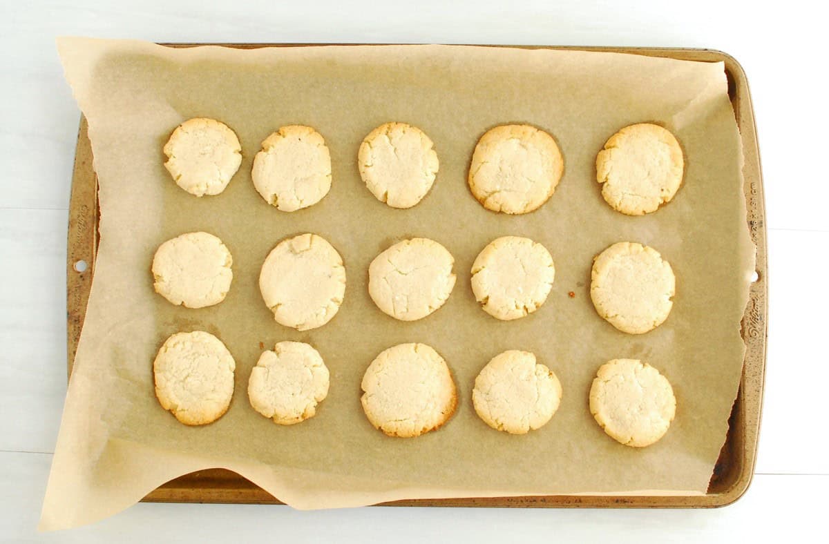 Just-baked almond flour cookies on a baking sheet.