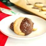 A close up of an almond flour shortbread cookie that was dipped in chocolate and sprinkled with coarse salt.