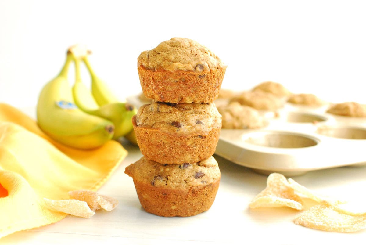 Three ginger banana muffins stacked on top of each other.