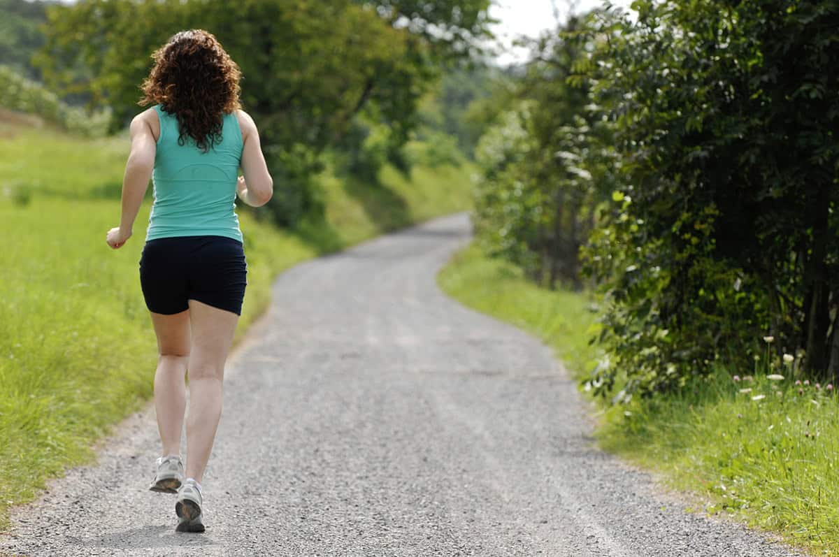 A woman running outside training for a marathon.