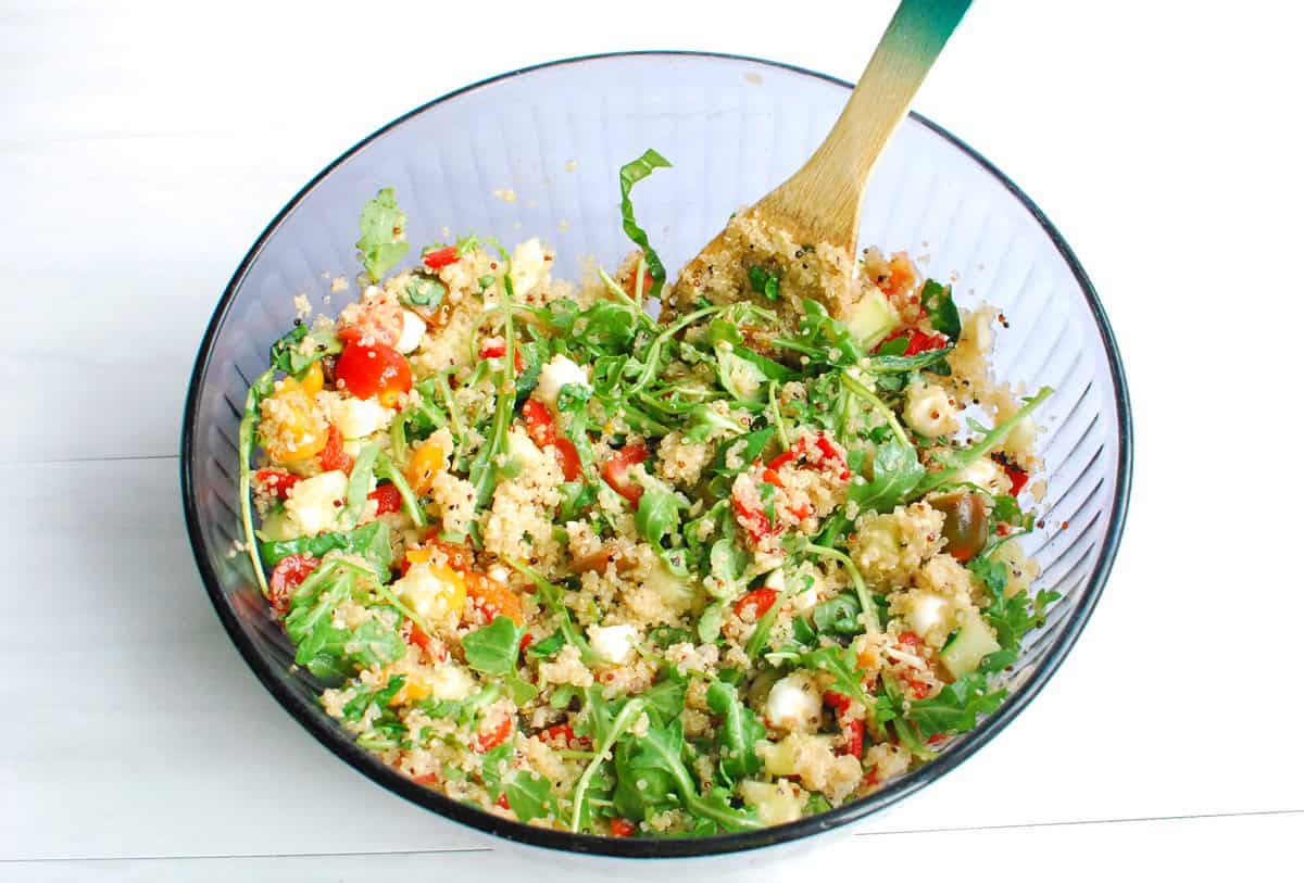 Quinoa added to the mixing bowl with vegetables and mozzarella.