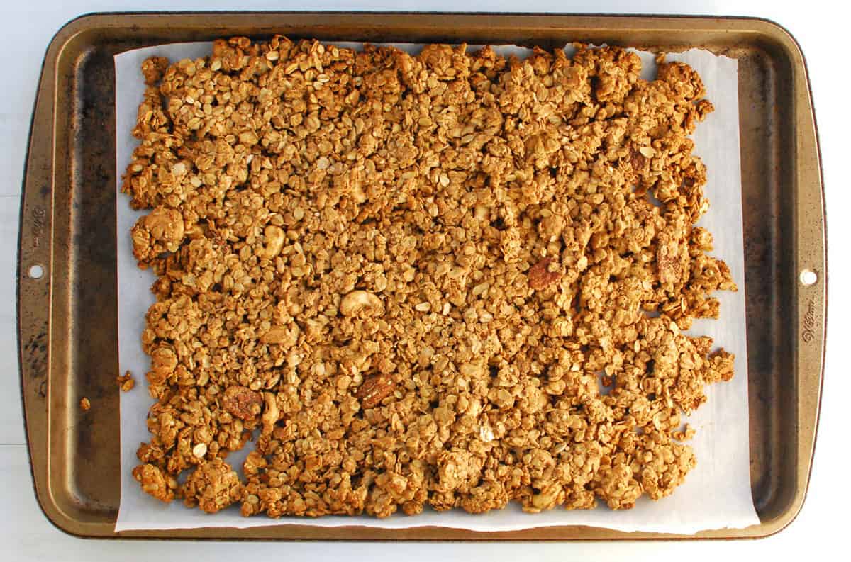 Baked granola cooling on the baking sheet.