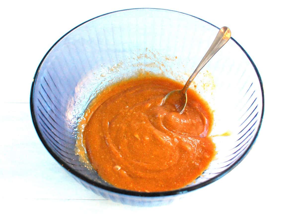 Egg whites, peanut butter, maple syrup, and olive oil mixed together in a bowl.