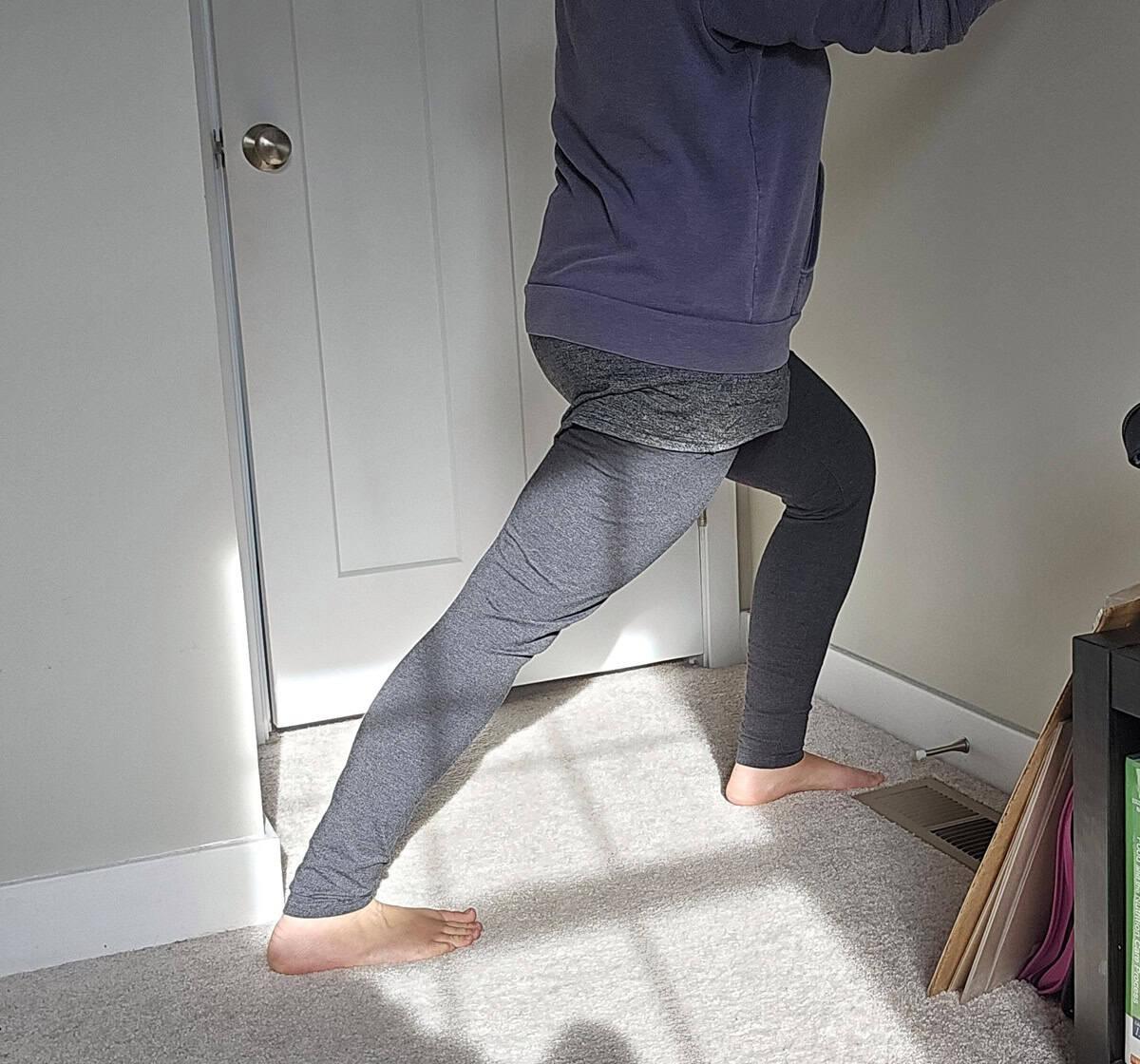 A woman doing a calf stretch.