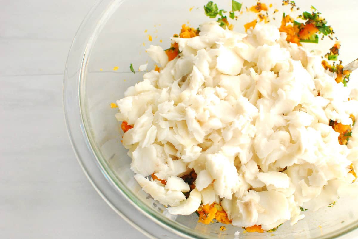 Cod flaked into the mixing bowl.