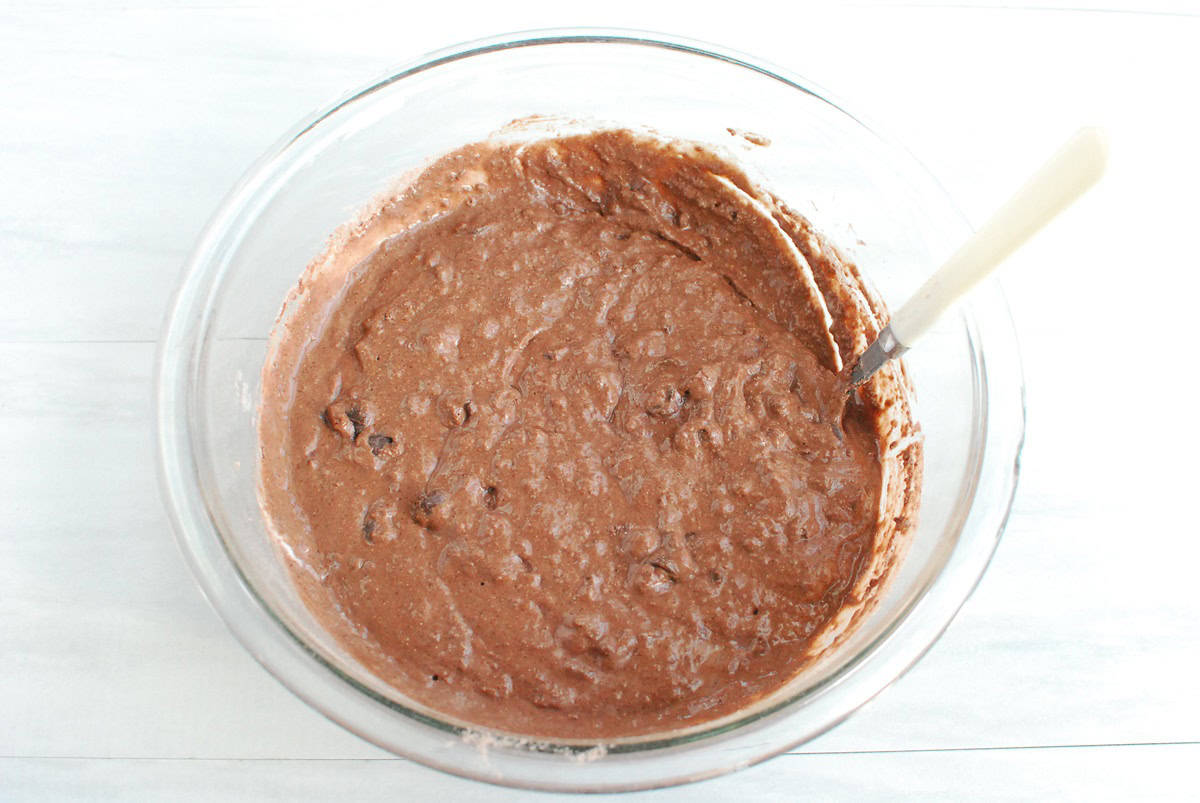 Muffin batter in a glass mixing bowl.