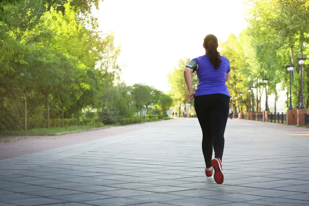 A woman running outside enjoying her time.