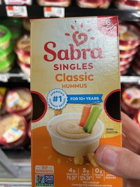 Mini hummus packets at a grocery store.