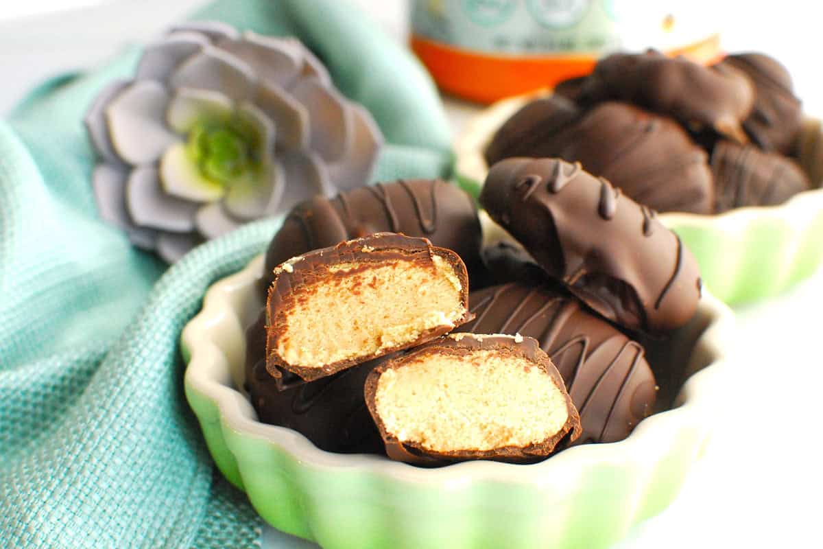 A peanut butter egg broken in half showing the peanut butter protein filling.