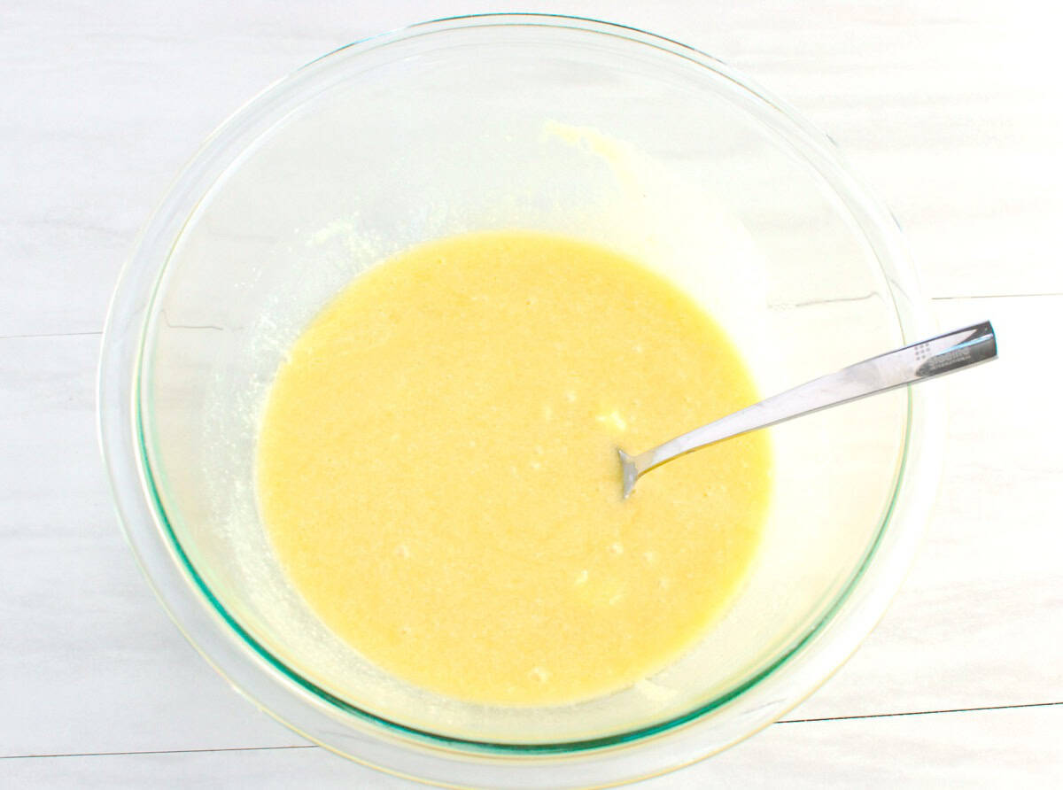 Melted butter, sugar, vanilla, and the cottage cheese/egg mixture all mixed together in a glass bowl.