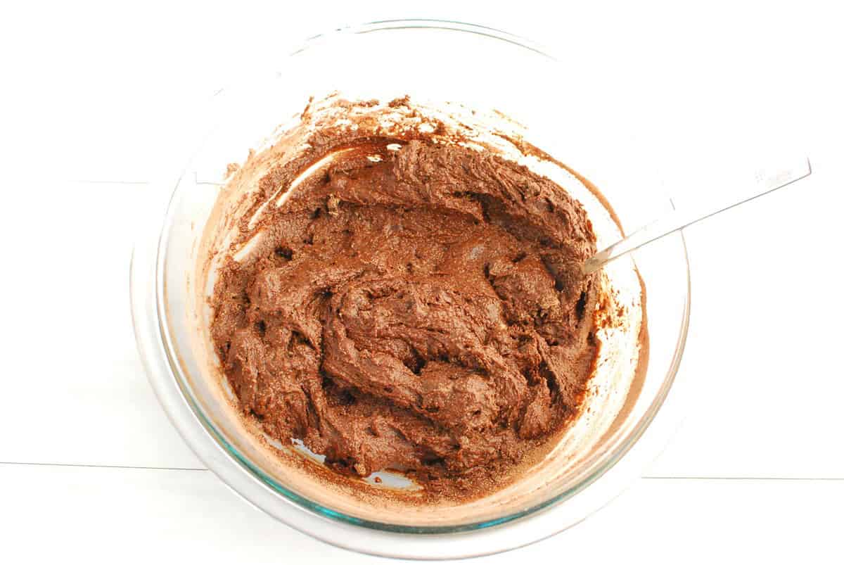 Brownie batter in a glass bowl.