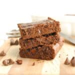 Three cottage cheese brownies stacked on top of each other.