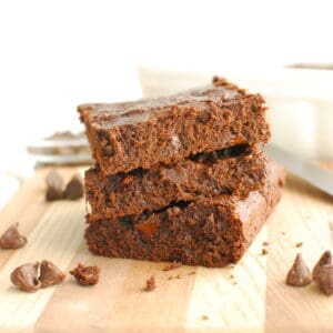 Three cottage cheese brownies stacked on top of each other.