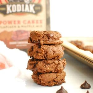 A stack of several dark chocolate cookies made with Kodiak pancake mix.