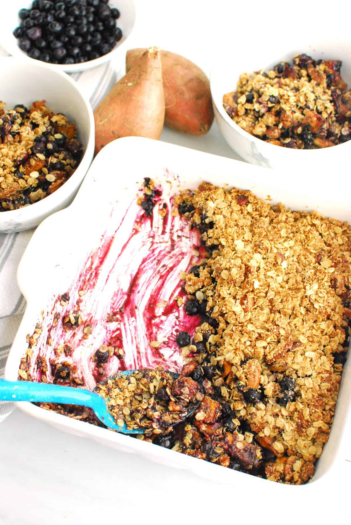 A half eaten dish of sweetpotato blueberry crsip.