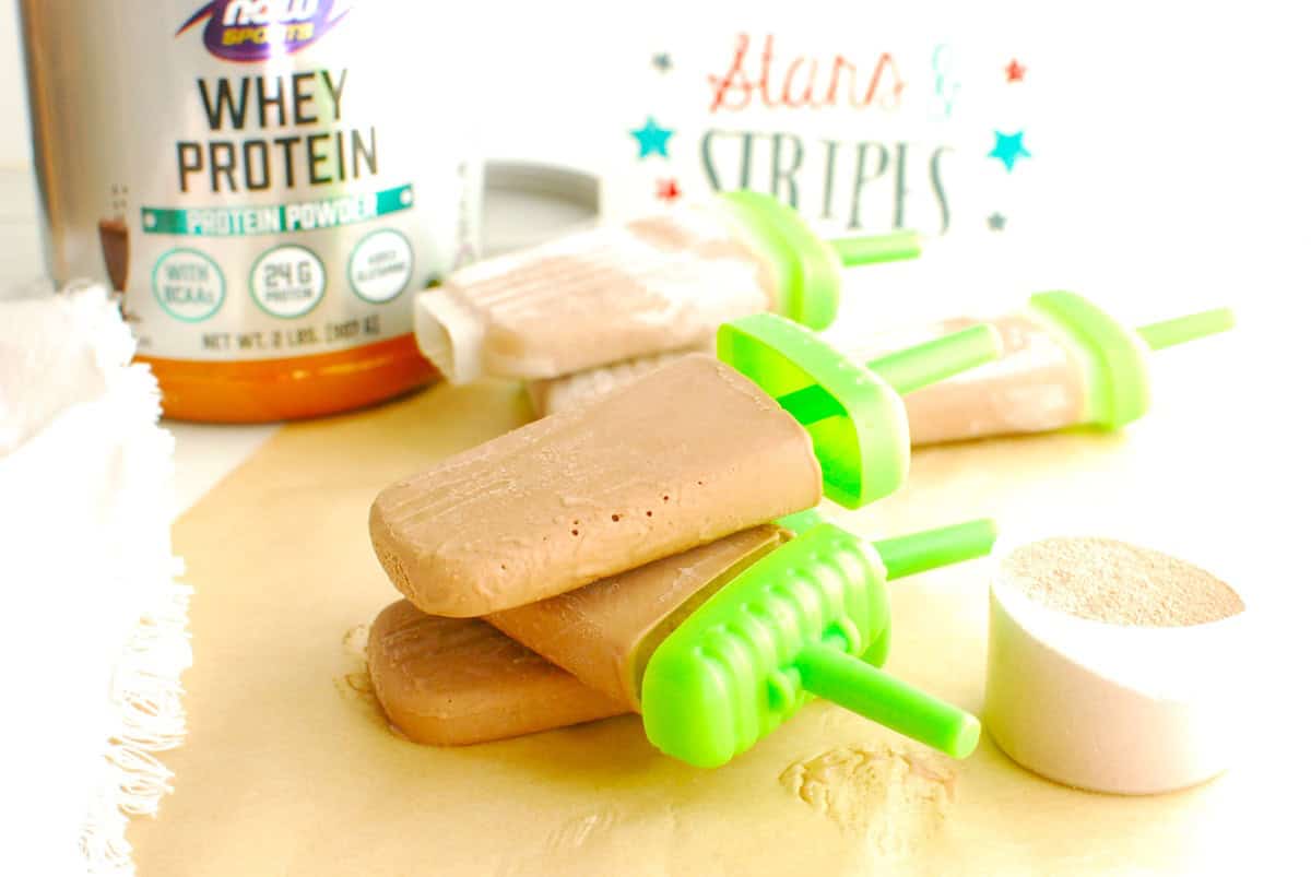 Three chocolate protein ice pops stacked on top of each other.