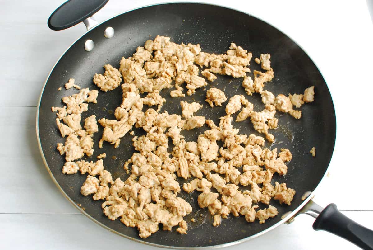 Cooked ground chicken in a large skillet.