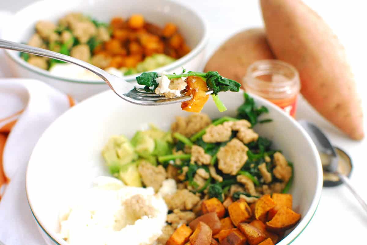 A fork with food on it from the breakfast bowl.
