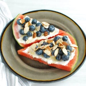 Watermelon ricotta pizza topped with blueberries, almonds, and honey.