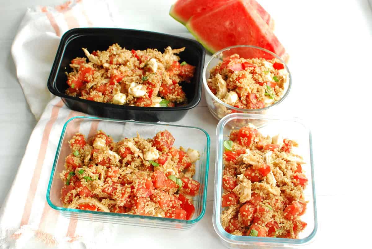Watermelon quinoa salad divided into four meal prep containers.