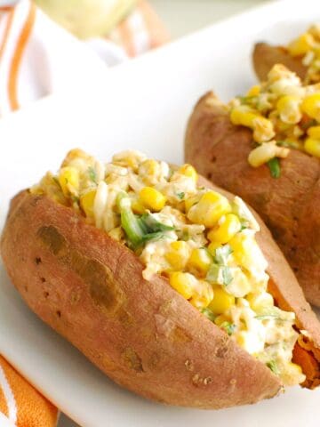 Street corn stuffed sweetpotatoes on a white platter.