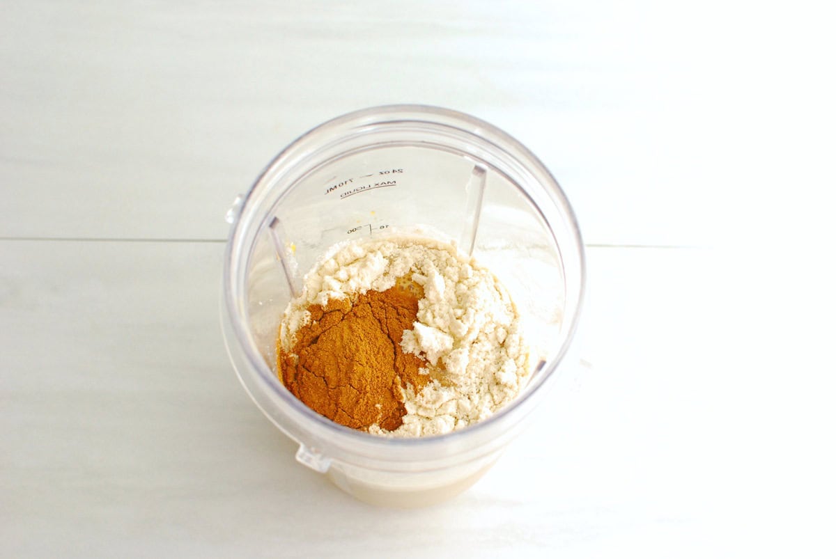 All of the ingredients added to a blender cup.