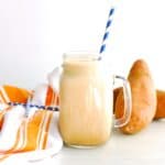 A mason jar filled with a protein-rich sweetpotato iced latte.